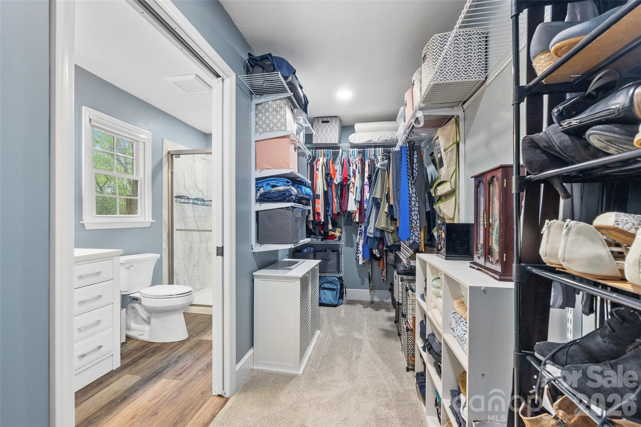 10500 Doylestown Road Matthews, NC 28105 - Photo 31 of 46 a view of walk in closet with clothes and shoes
