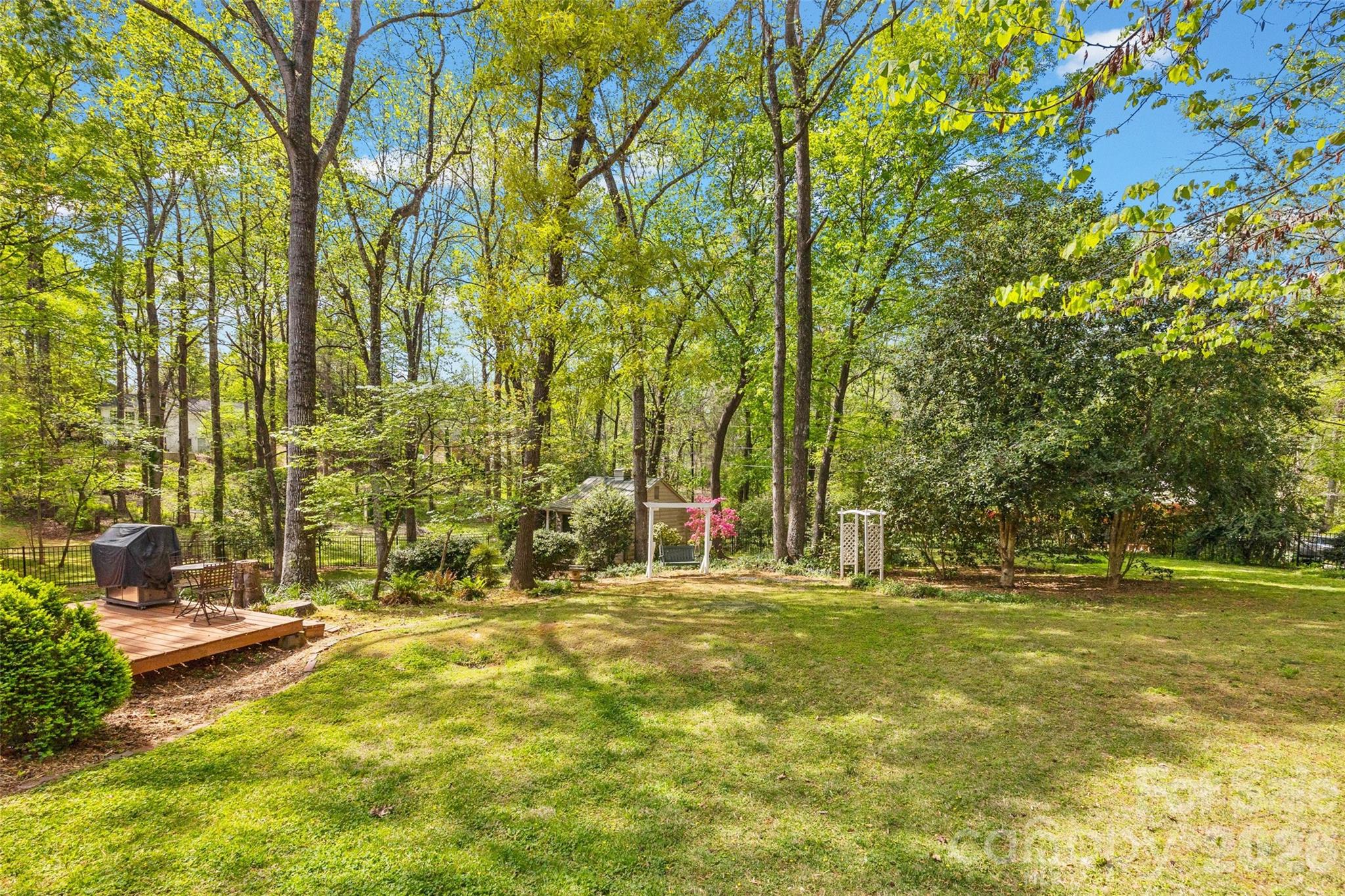 10500 Doylestown Road Matthews, NC 28105 - Photo 36 of 46 a view of swimming pool with lawn chairs and large trees