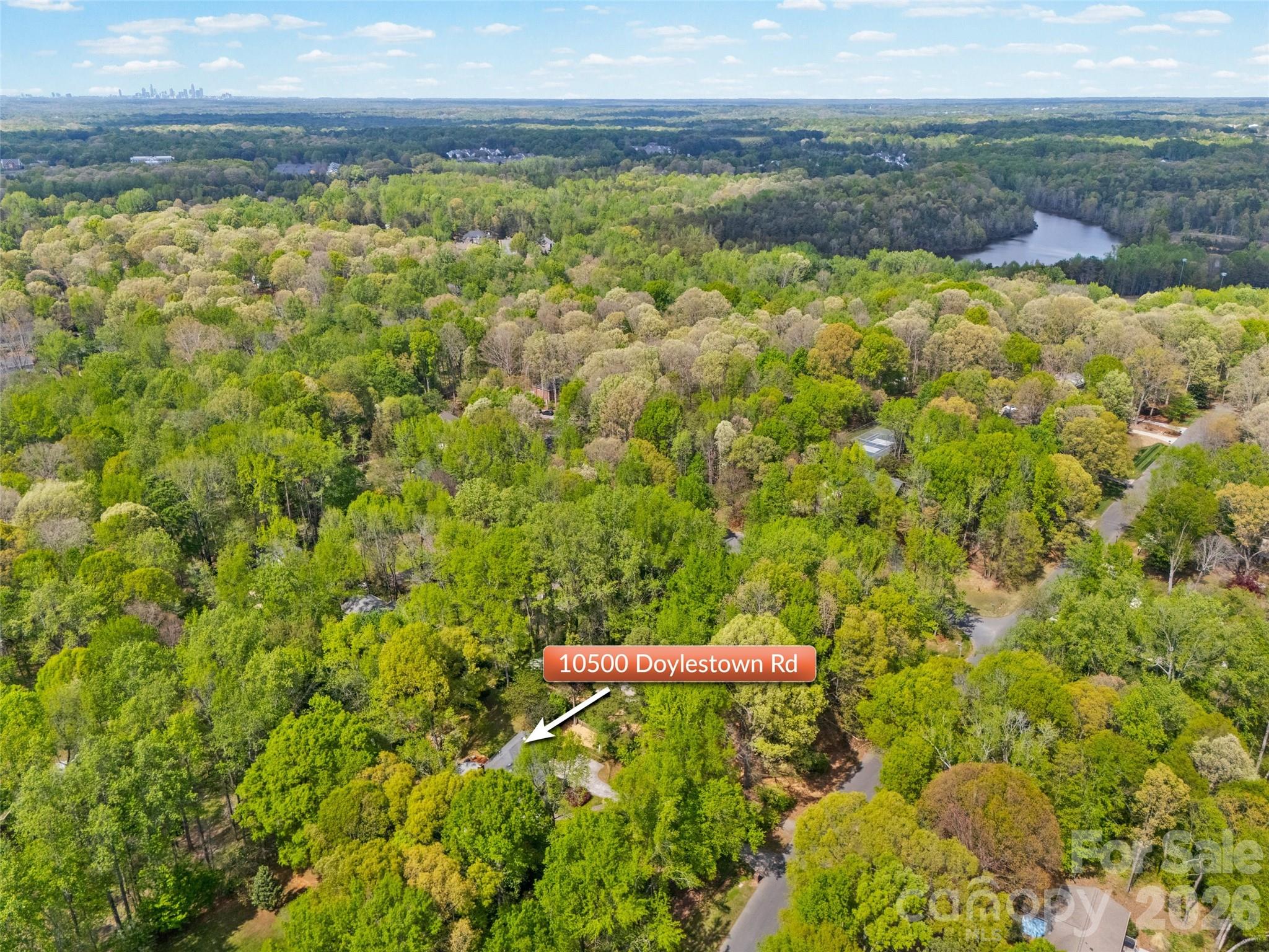 10500 Doylestown Road Matthews, NC 28105 - Photo 44 of 46 a view of a lake with a yard