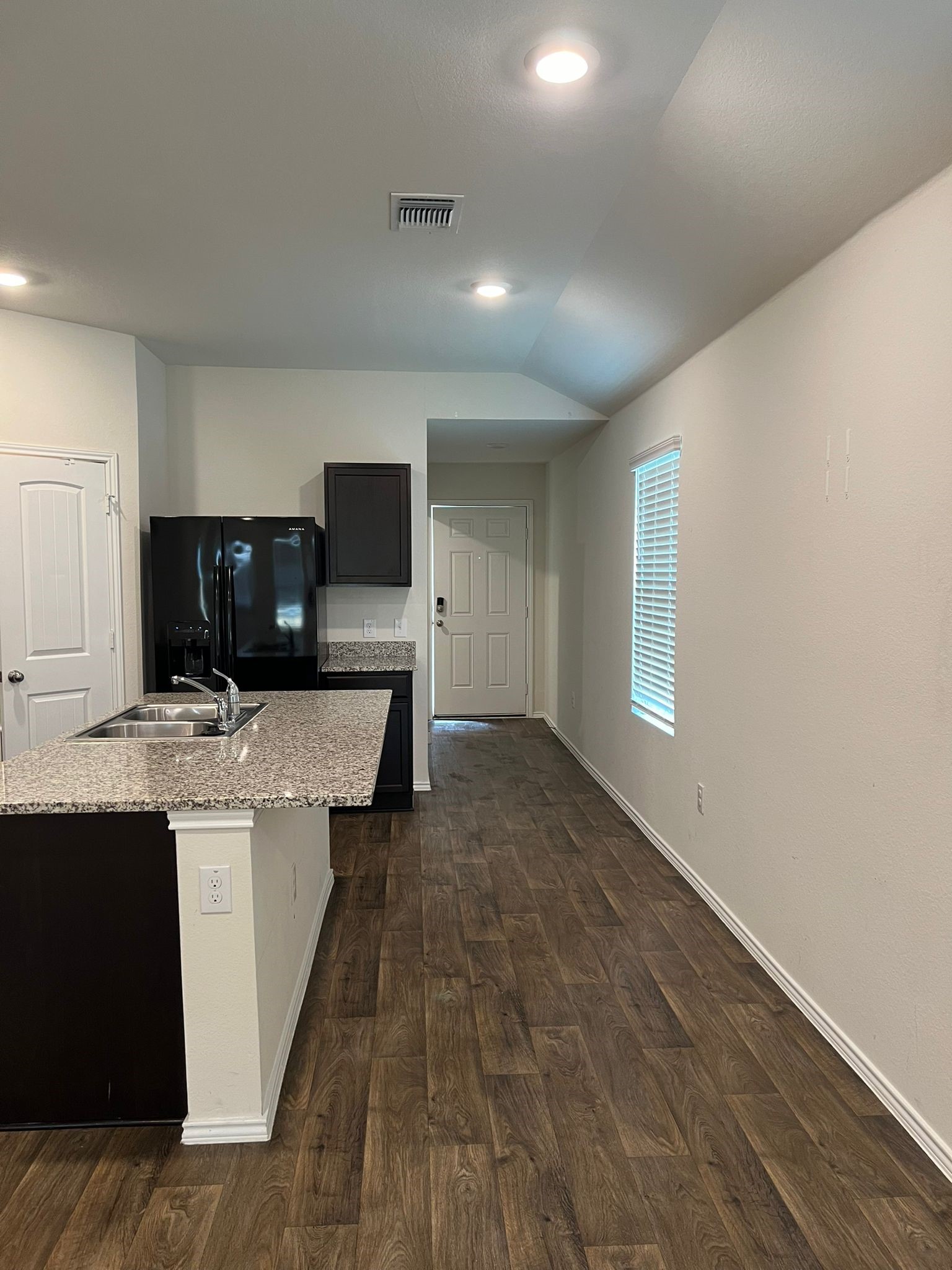 14901 Bajada Rd Manor Manor, TX 78653 - Photo 3 of 14 a living room with stainless steel appliances kitchen island granite countertop a sink and a stove top oven with wooden floor