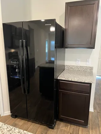 a kitchen with a refrigerator and a sink