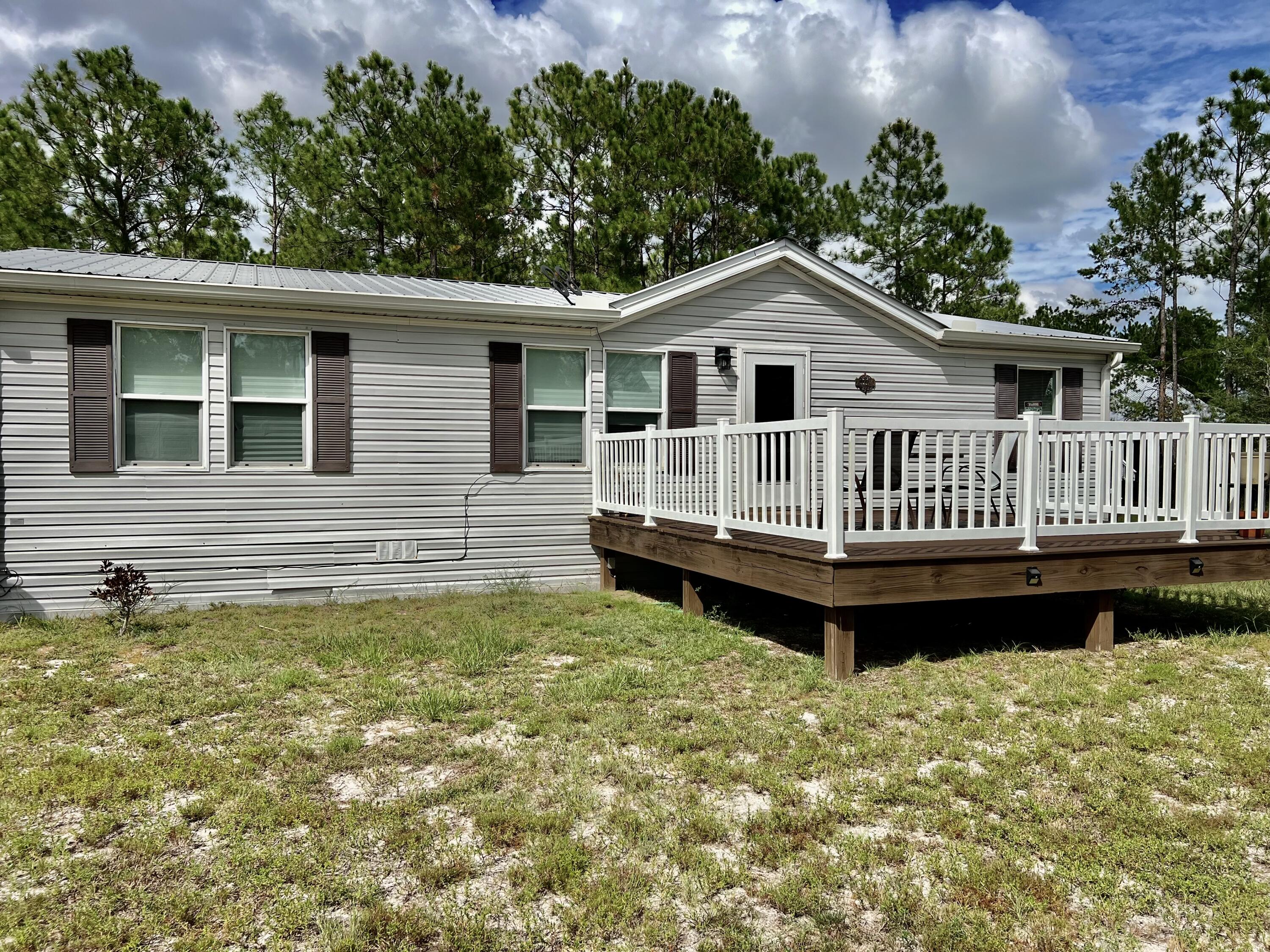403 Don Graff Road Freeport, FL 32439 - Photo 1 of 34 a front view of a house with garden