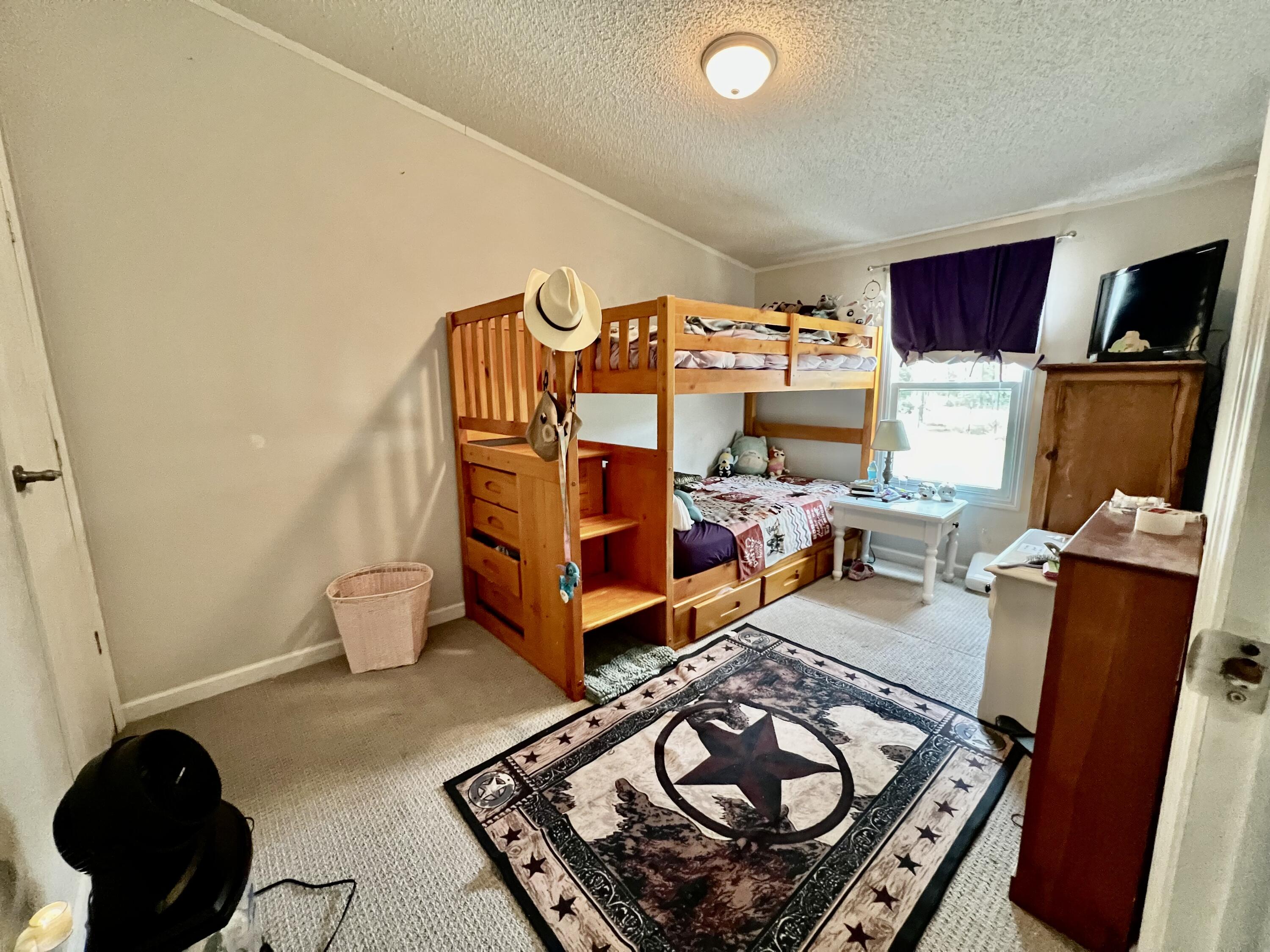 403 Don Graff Road Freeport, FL 32439 - Photo 15 of 34 a bedroom with furniture and a large window