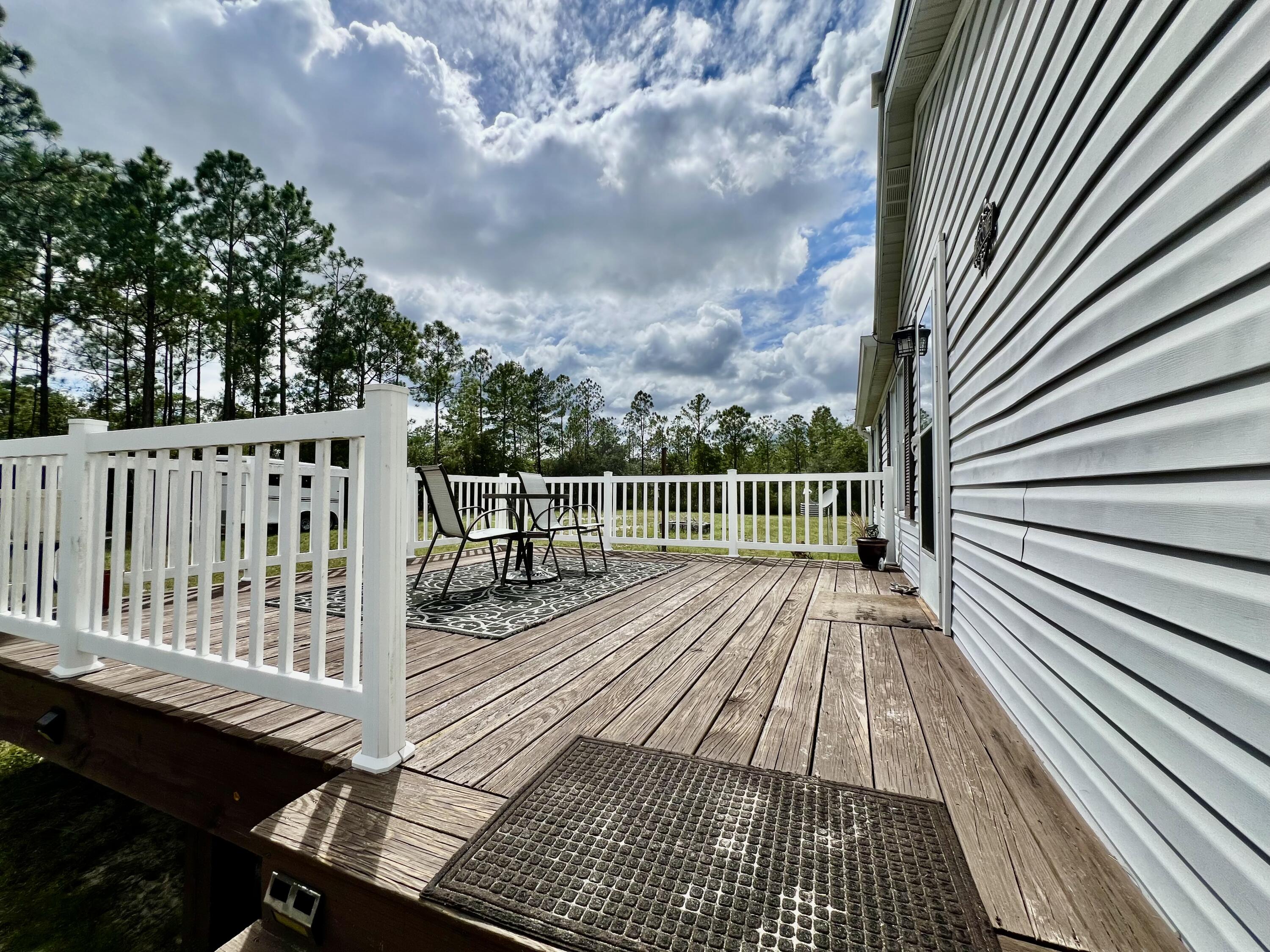 403 Don Graff Road Freeport, FL 32439 - Photo 16 of 34 a view of deck with wooden floor and fence