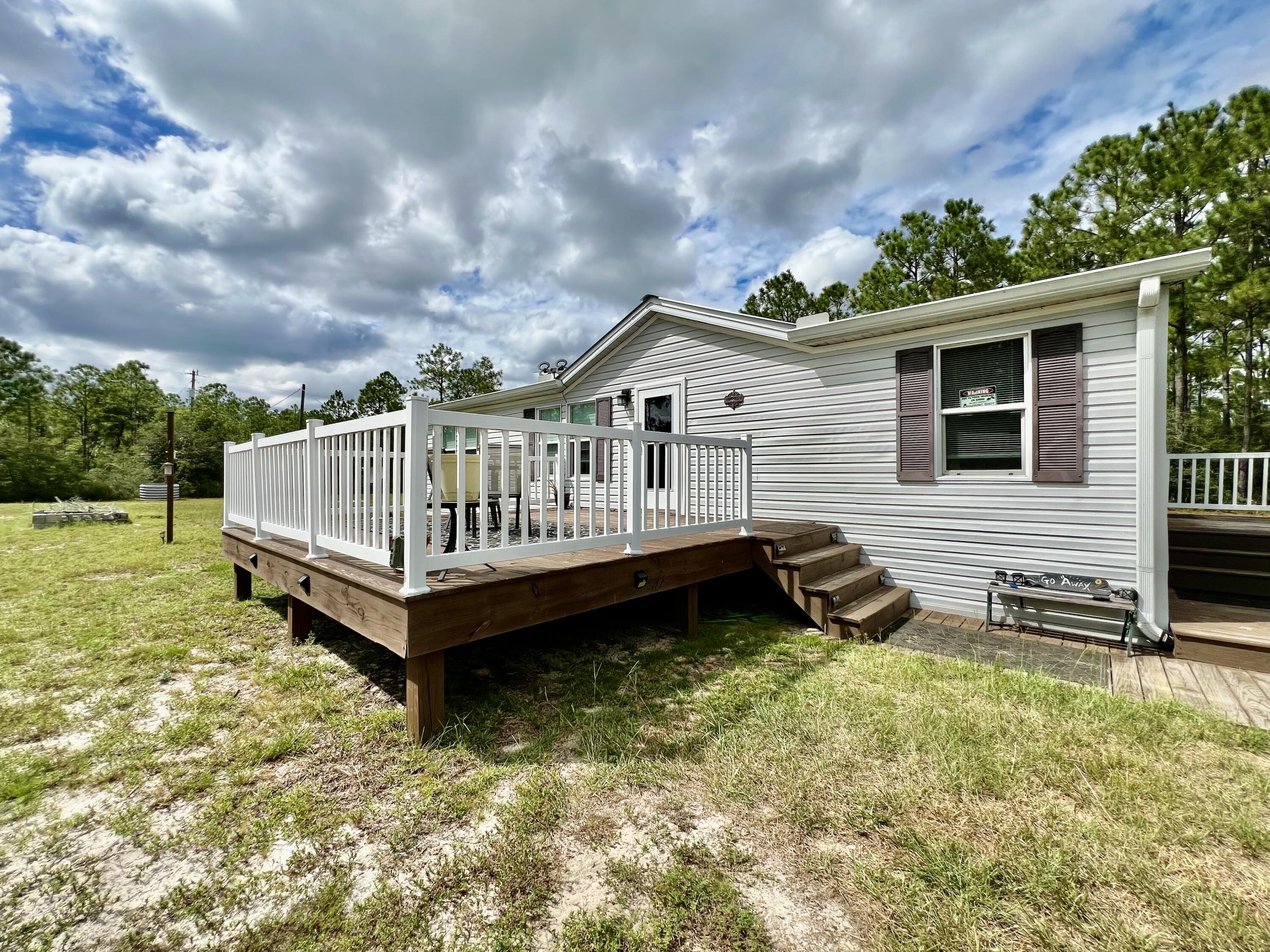 403 Don Graff Road Freeport, FL 32439 - Photo 17 of 34 a view of a house with a yard and sitting area