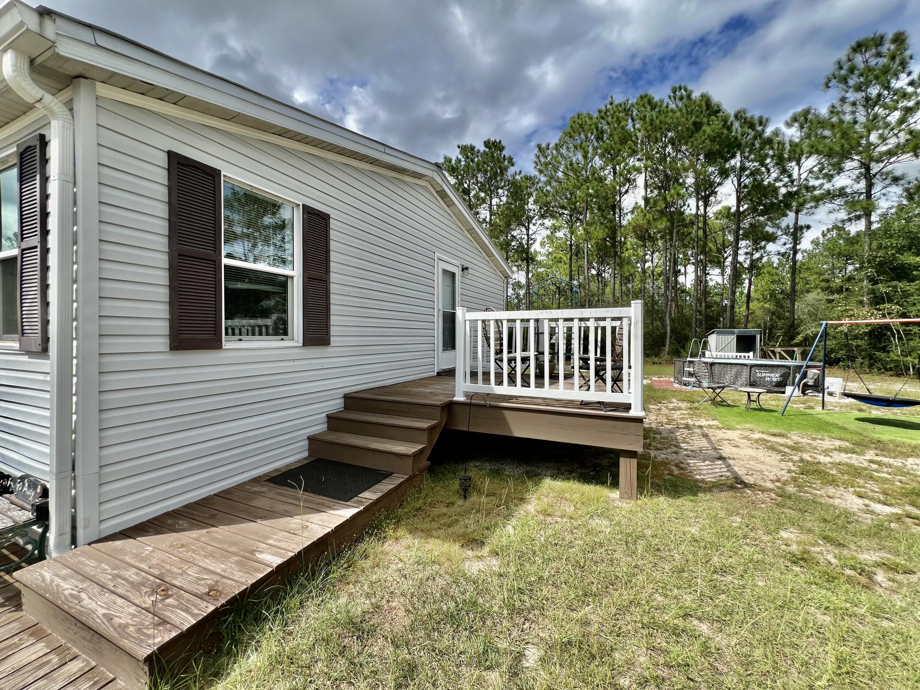 403 Don Graff Road Freeport, FL 32439 - Photo 18 of 34 a view of a house with backyard and sitting area