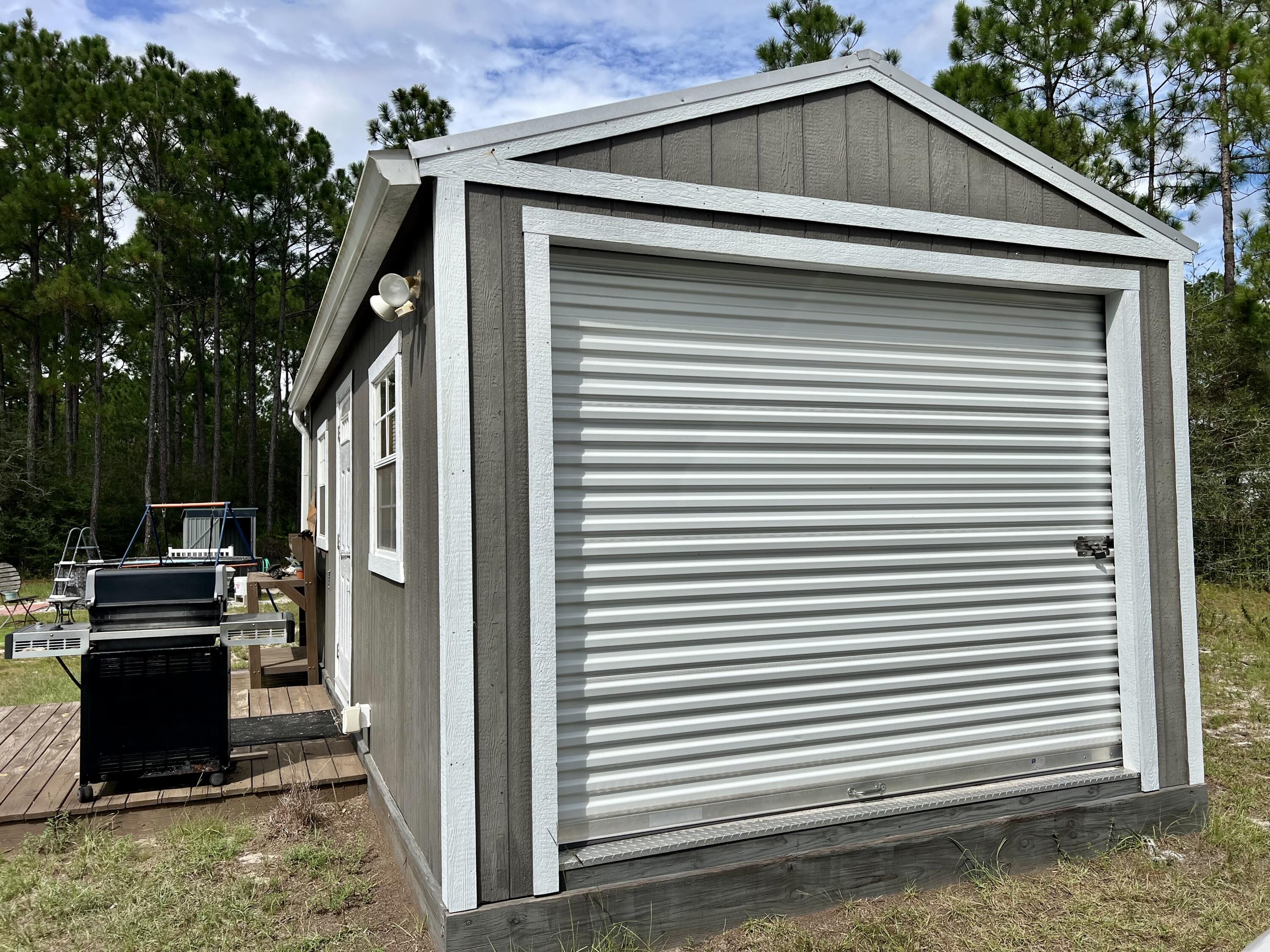 403 Don Graff Road Freeport, FL 32439 - Photo 20 of 34 a view of a storage house in the background