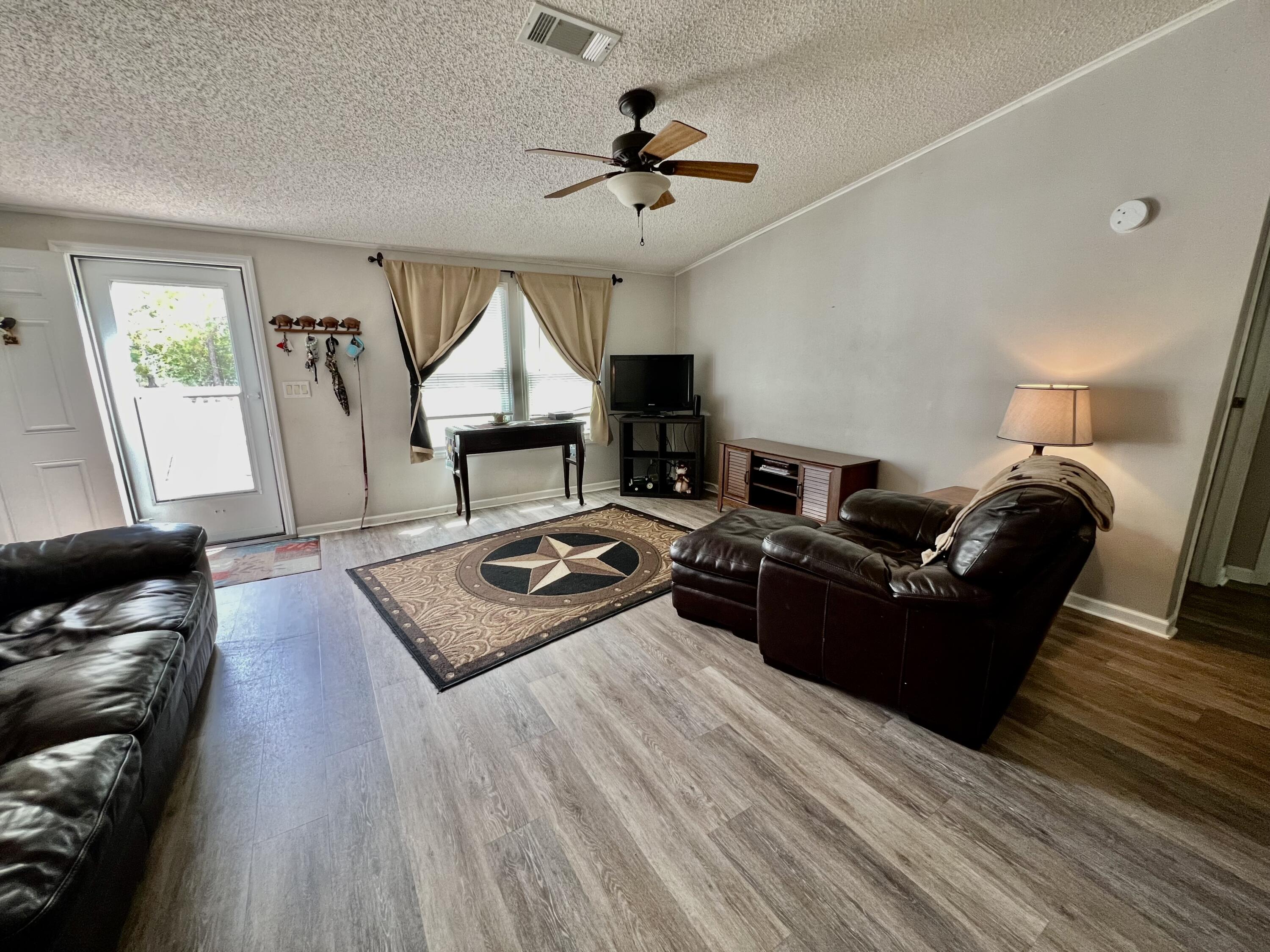 403 Don Graff Road Freeport, FL 32439 - Photo 2 of 34 a living room with furniture and a flat screen tv
