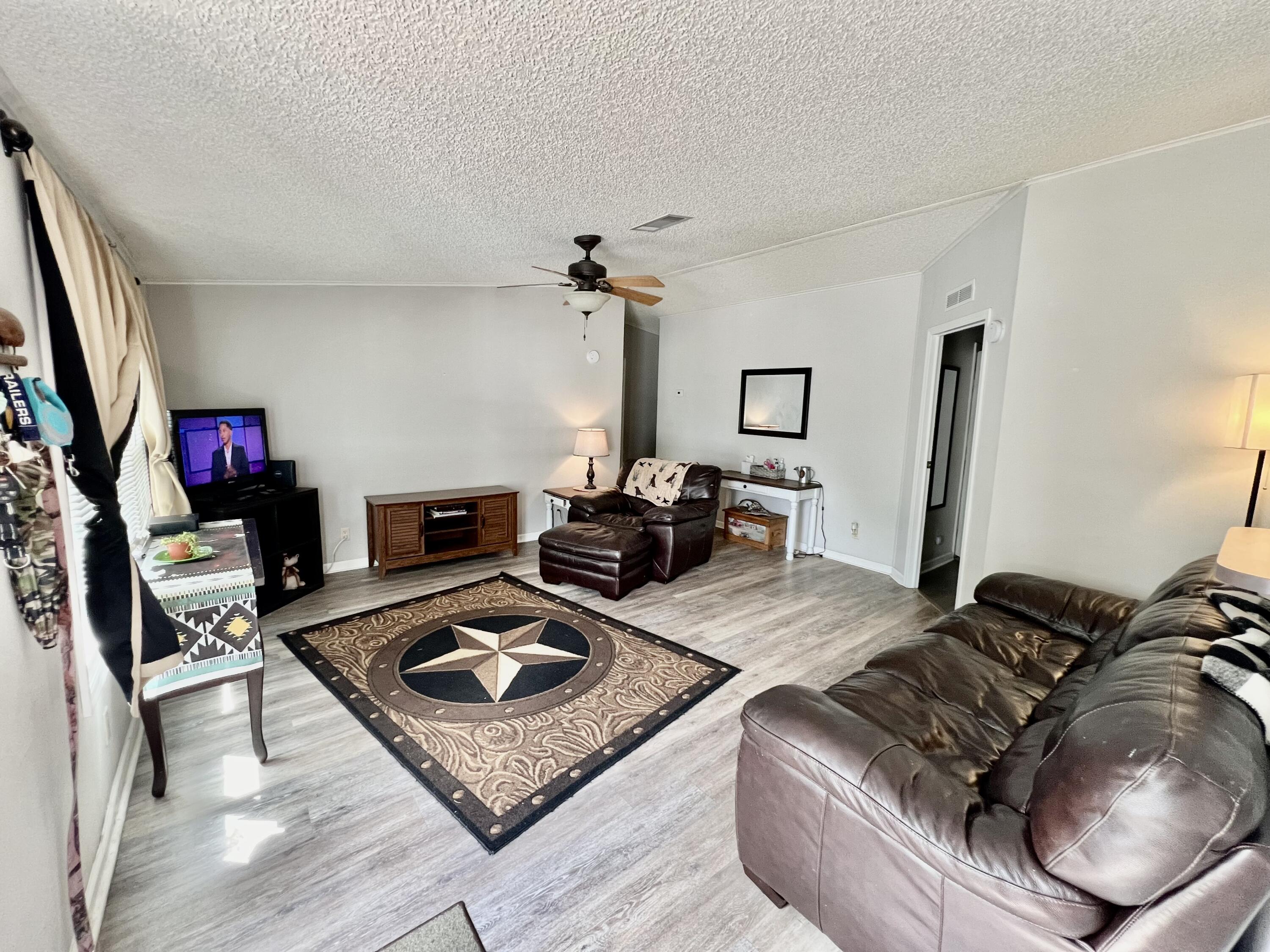 403 Don Graff Road Freeport, FL 32439 - Photo 3 of 34 a living room with furniture and a flat screen tv