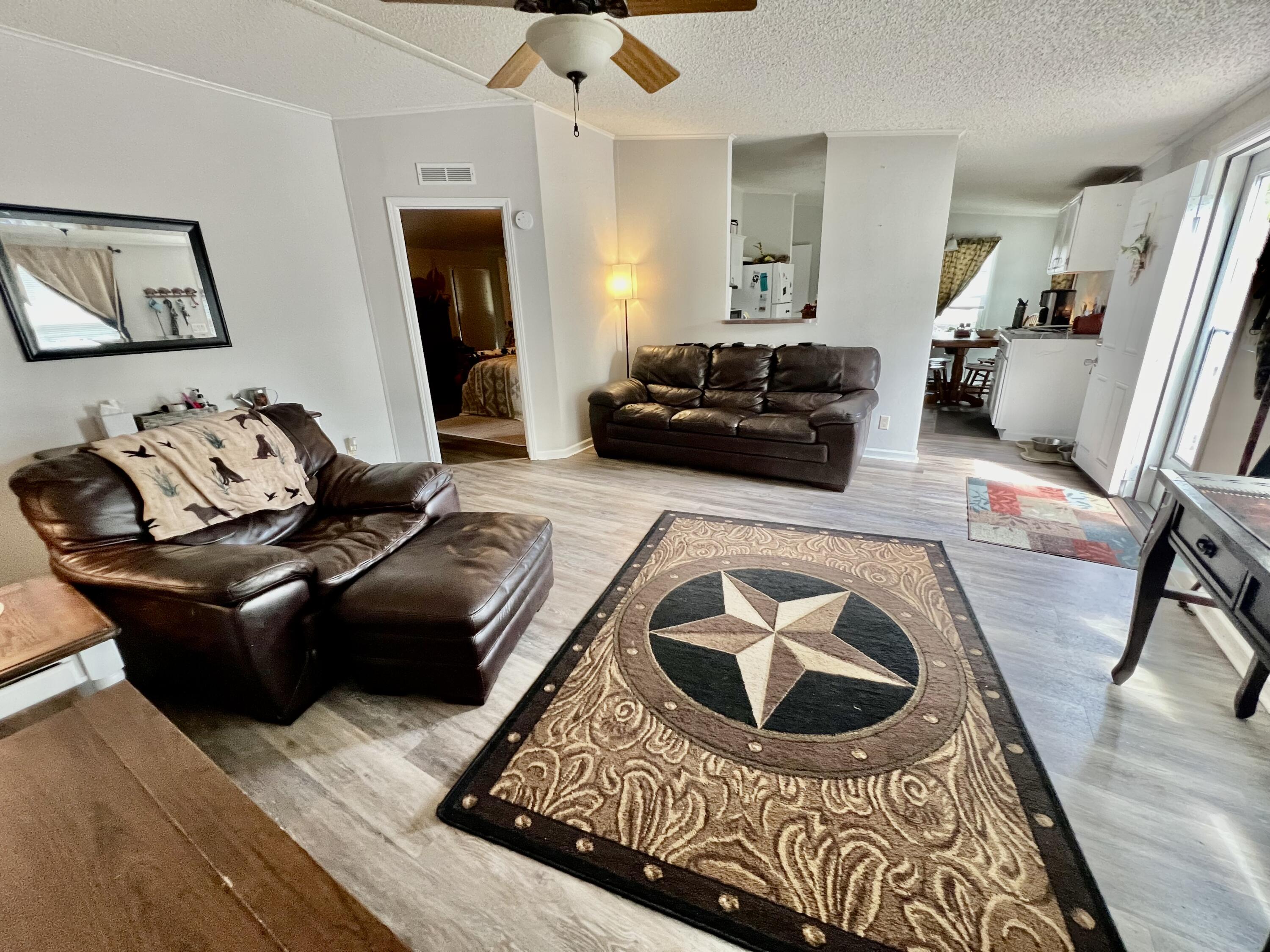 403 Don Graff Road Freeport, FL 32439 - Photo 4 of 34 a living room with furniture and a wooden floor