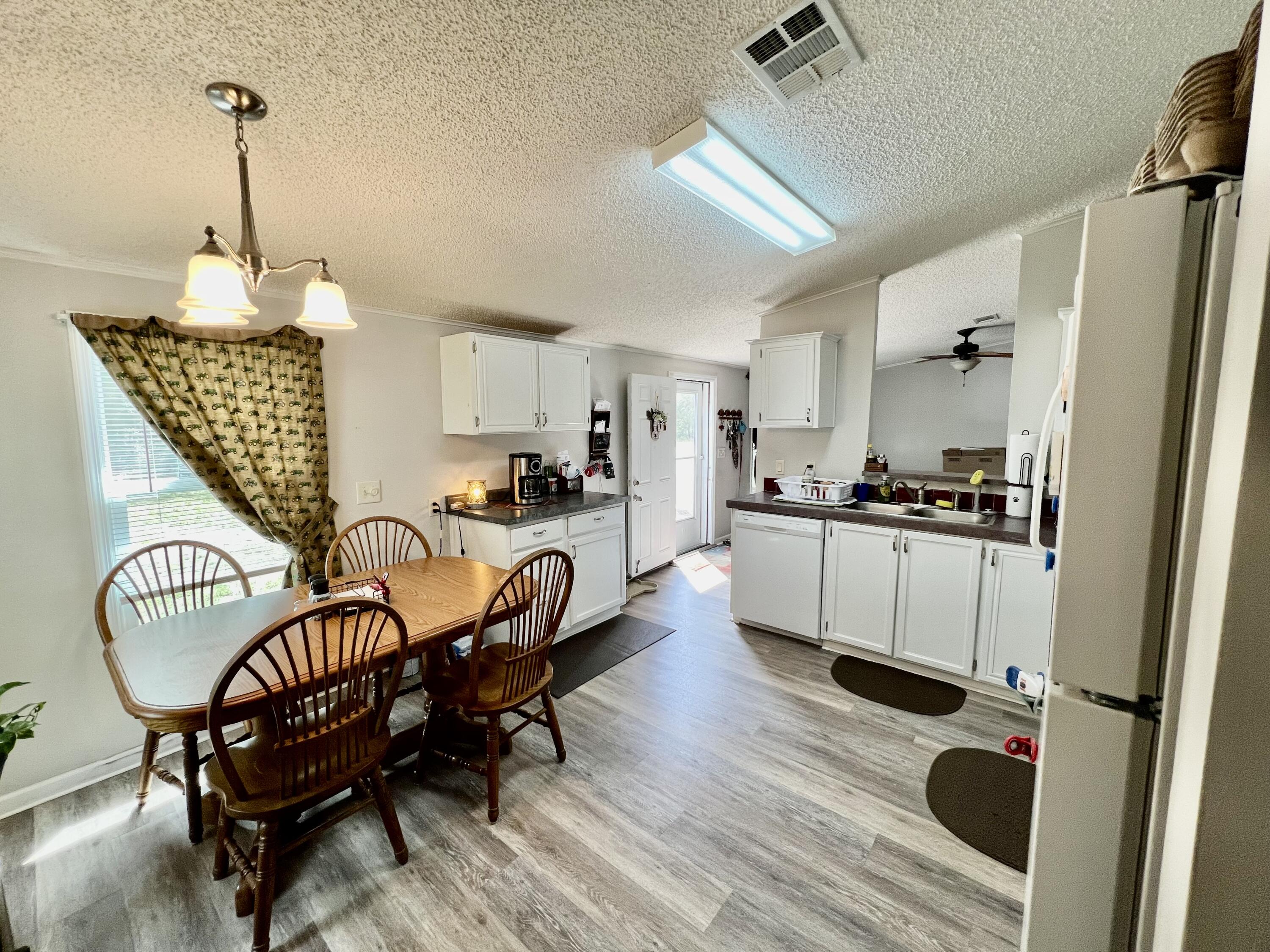 403 Don Graff Road Freeport, FL 32439 - Photo 5 of 34 a living room with furniture and a wooden floor