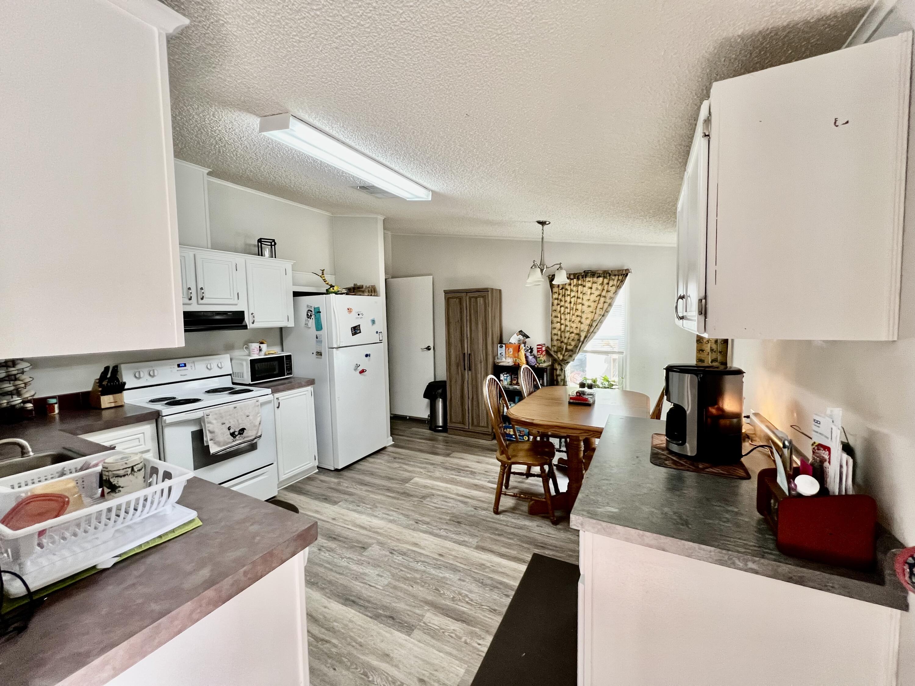 403 Don Graff Road Freeport, FL 32439 - Photo 6 of 34 a kitchen with stainless steel appliances granite countertop a refrigerator stove microwave and sink