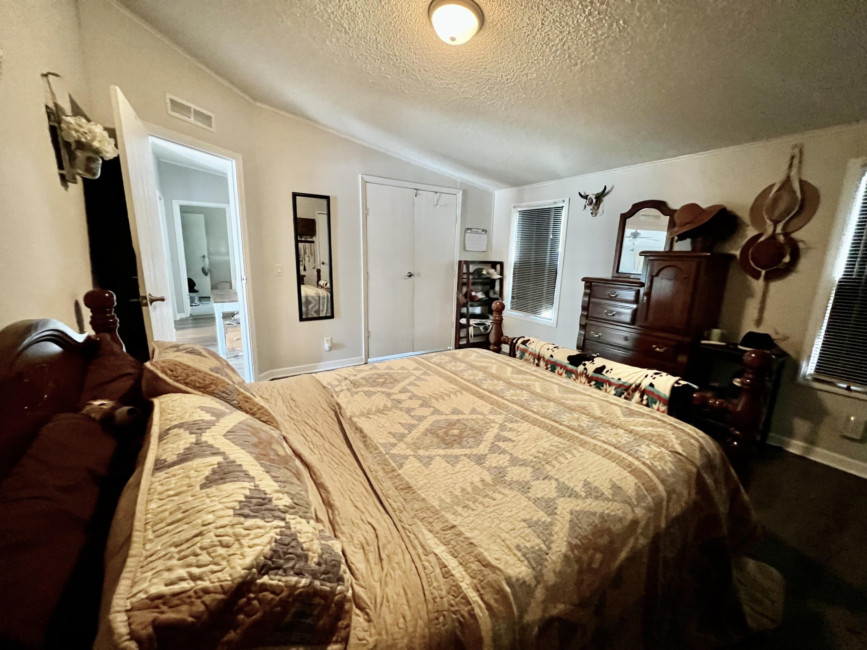 403 Don Graff Road Freeport, FL 32439 - Photo 9 of 34 a bedroom with a bed and a mirror