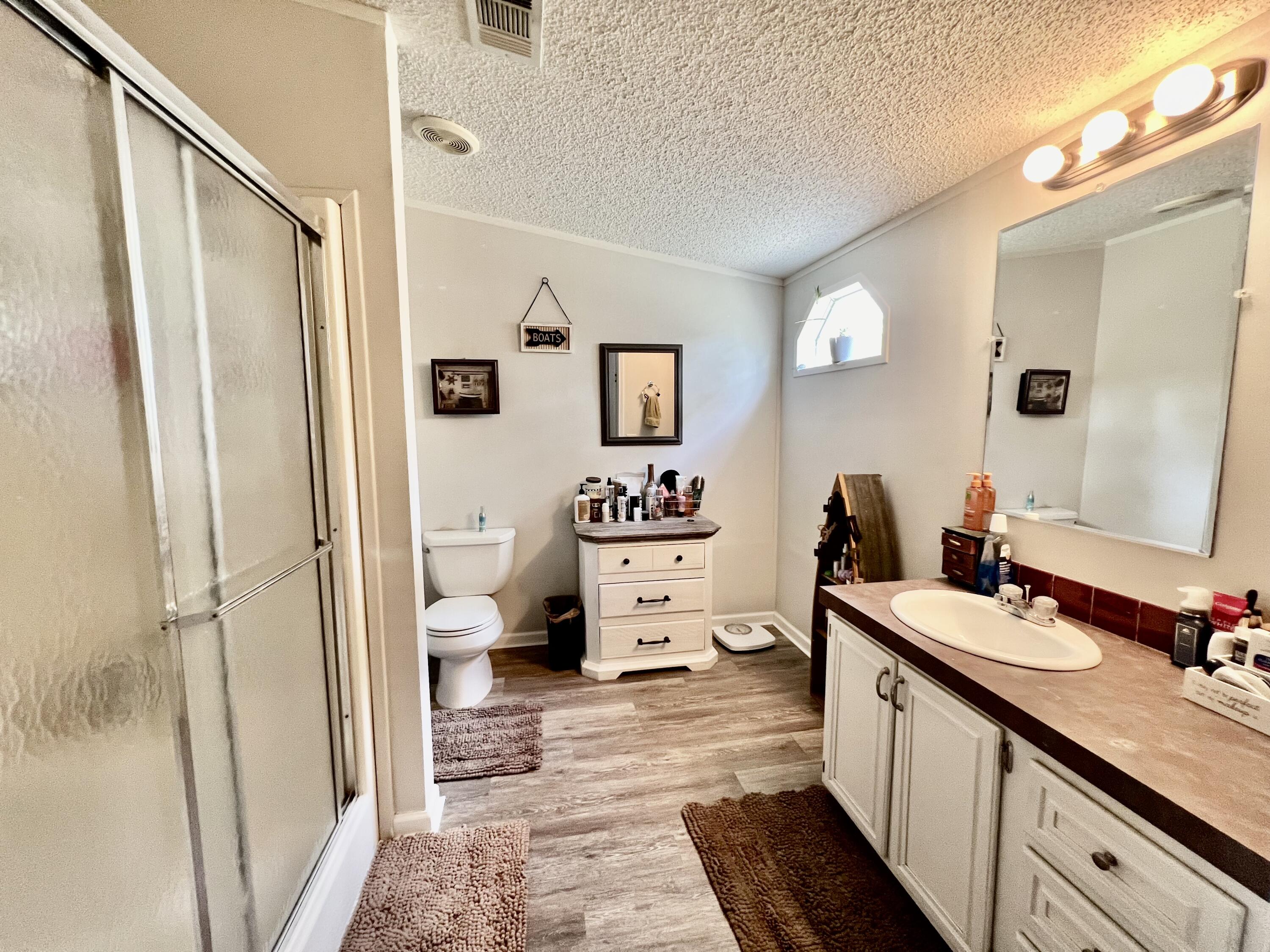 403 Don Graff Road Freeport, FL 32439 - Photo 10 of 34 a en suite bathroom with a double vanity sink a mirror and a shower