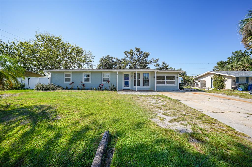 a front view of house with yard and green space