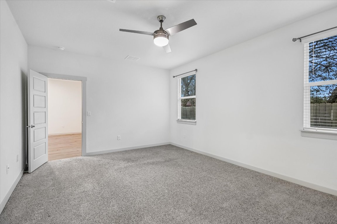132 Shawii Pass Leander, TX 78641 - Photo 12 of 35 Spacious primary bedroom with two windows to provide natural lighting privately situated at the back of the home.