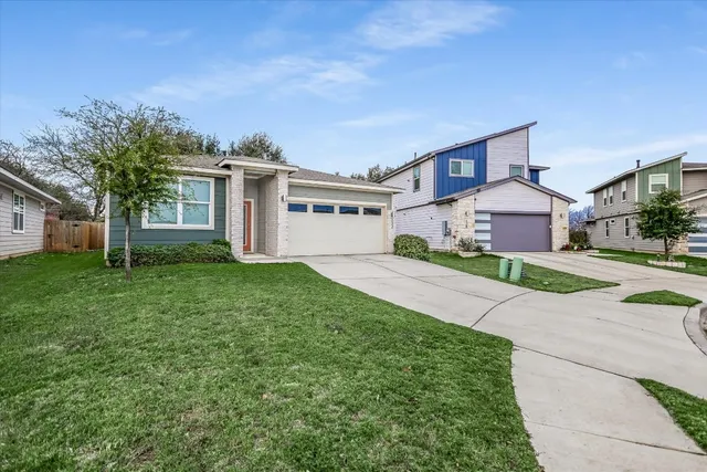 a front view of house with yard and green space