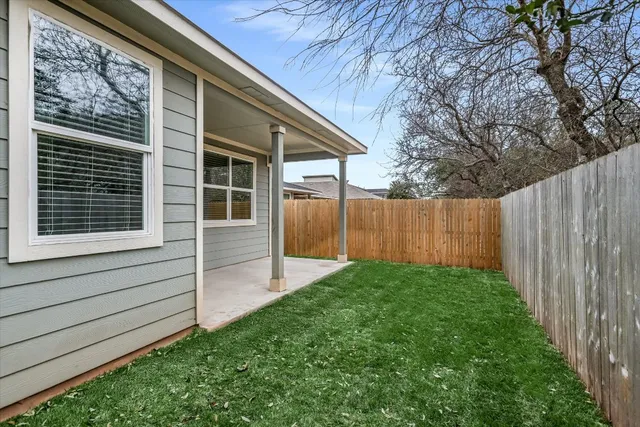 a view of house with backyard