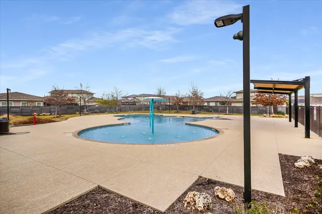 a view of a swimming pool with a yard