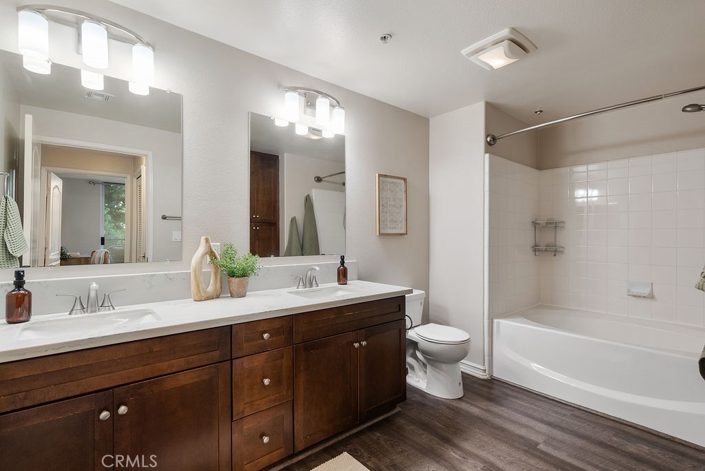 629 Traction Avenue, Unit 312 Los Angeles, CA 90013 - Photo 14 of 45 a bathroom with a double vanity sink toilet mirror and bathtub