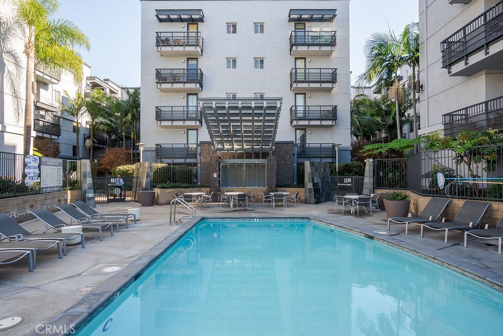 629 Traction Avenue, Unit 312 Los Angeles, CA 90013 - Photo 26 of 45 a view of pool with outdoor seating and house in the background