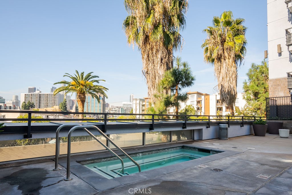 629 Traction Avenue, Unit 312 Los Angeles, CA 90013 - Photo 28 of 45 a view of swimming pool with outdoor seating and a palm tree