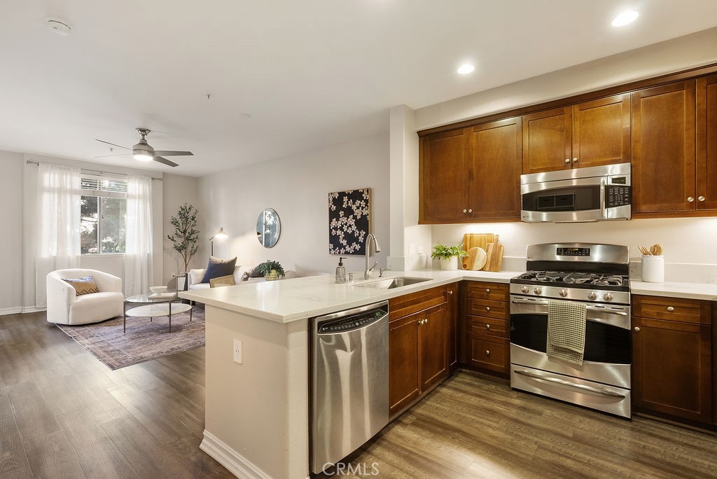 629 Traction Avenue, Unit 312 Los Angeles, CA 90013 - Photo 3 of 45 a kitchen with stainless steel appliances a sink stove and wooden floor