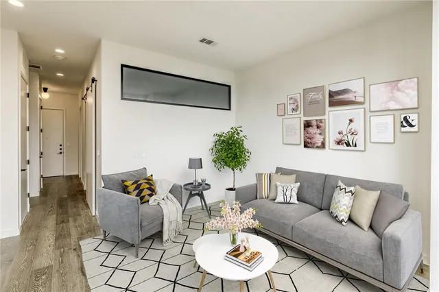 a living room with furniture and wooden floor