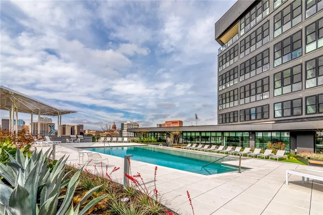 a view of swimming pool with outdoor seating and a pathway
