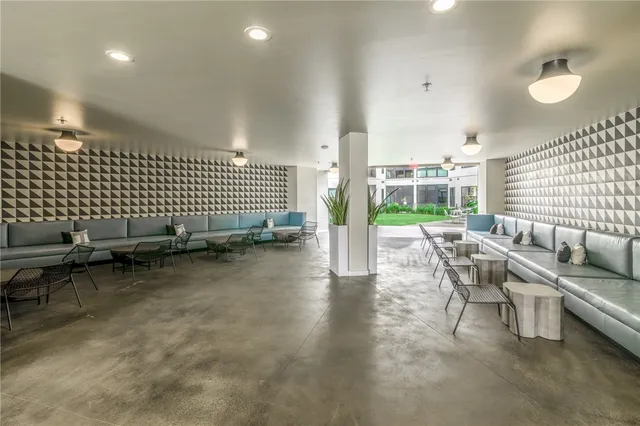 a living room with furniture and a floor to ceiling window