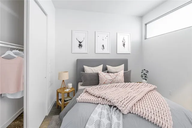 a bedroom with a bed and painting on the wall