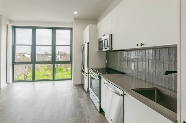 a kitchen with a sink and a large window