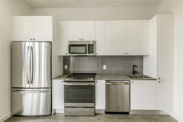 a kitchen with a refrigerator stove and microwave