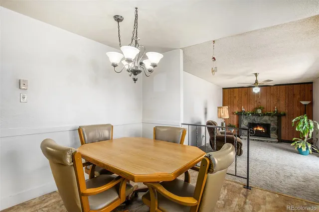 a view of a dining room with furniture and a chandelier