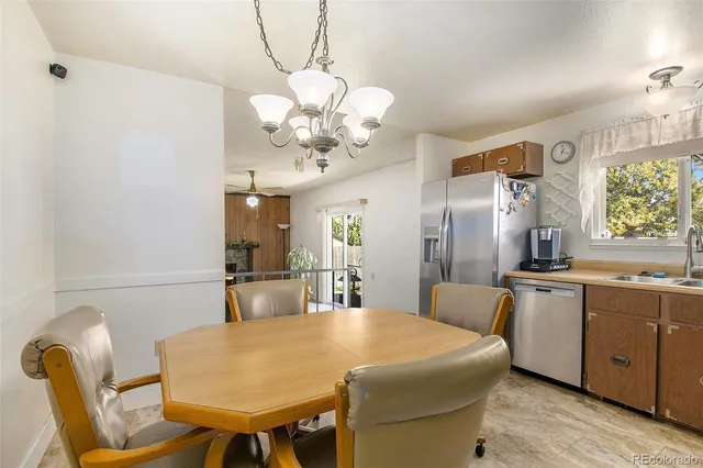 a large kitchen with a table and chairs
