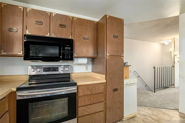 a kitchen with stainless steel appliances a stove a microwave and a refrigerator