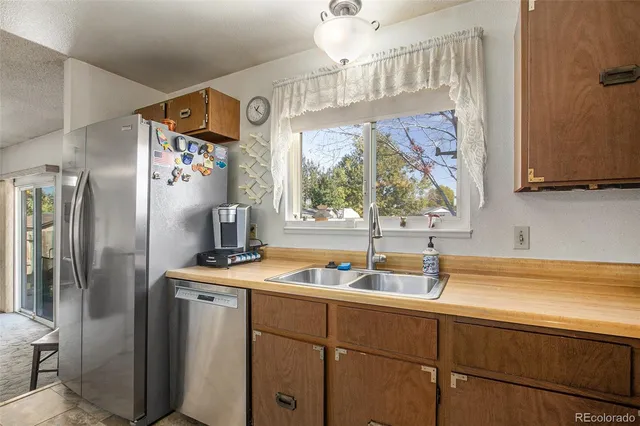 a kitchen with a sink refrigerator and microwave