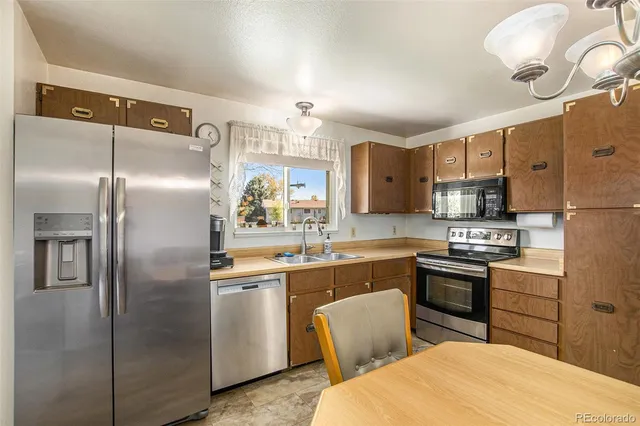 a kitchen with cabinets and stainless steel appliances