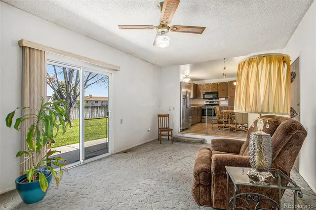 a work room with furniture and a potted plant