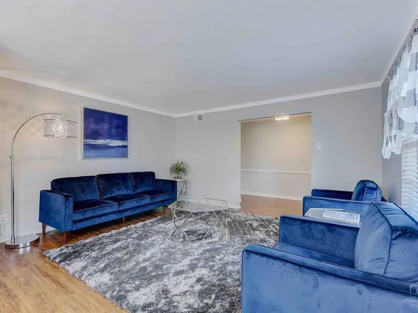 a living room with furniture and a rug