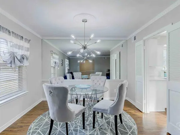 a view of a dining room with furniture window and wooden floor