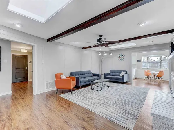 a living room with furniture and wooden floor
