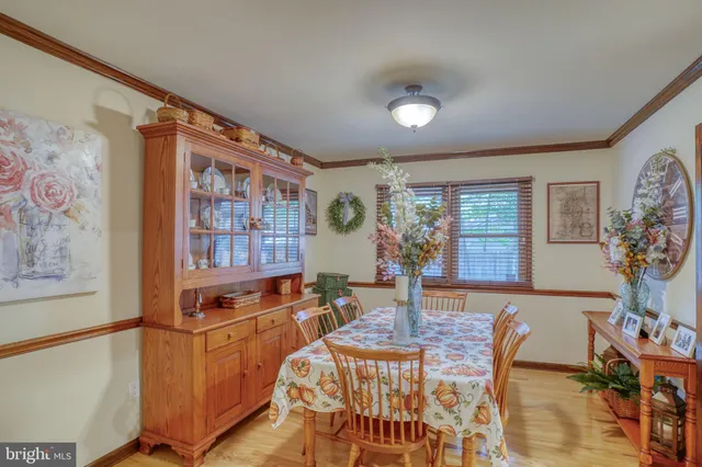 a living room with furniture and paintings on the wall
