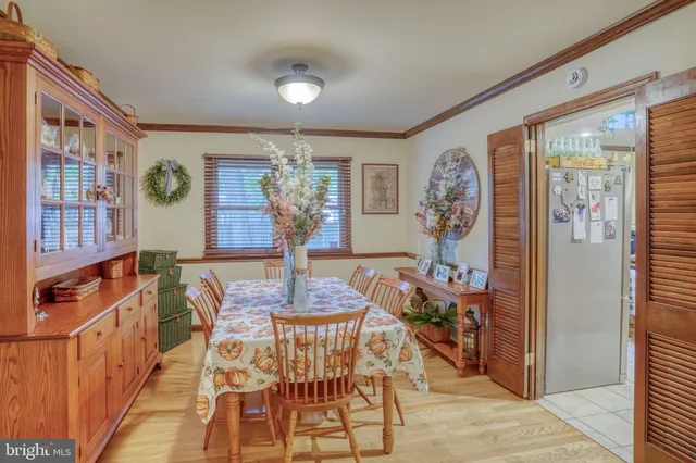 a dining room with furniture and wooden floor