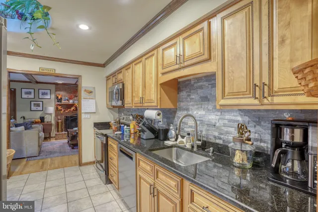 a kitchen with stainless steel appliances granite countertop a sink and cabinets