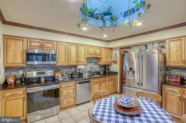 a kitchen with stainless steel appliances granite countertop a sink and cabinets