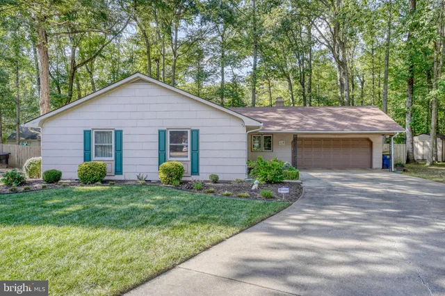 a view of house with backyard and garden