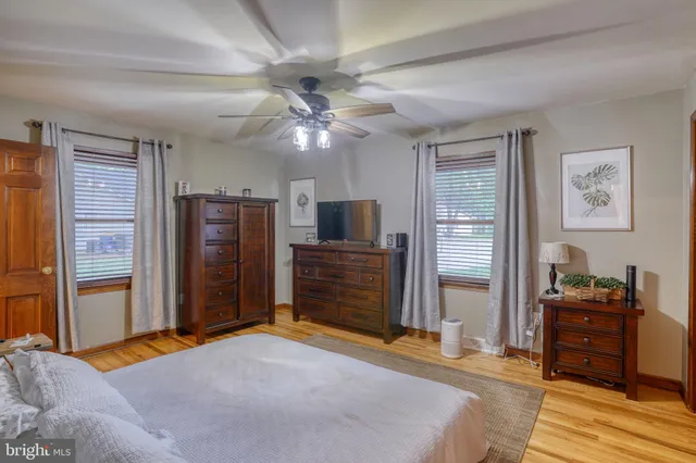 a bedroom with furniture and a flat screen tv