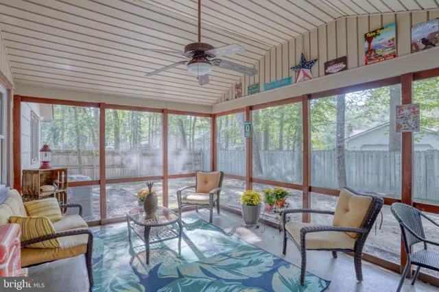 a view of a dining room with furniture large windows and wooden floor