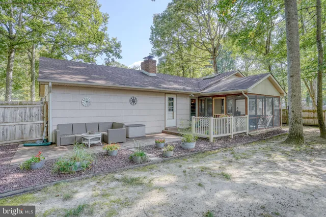 a backyard of a house with garden barbeque oven and outdoor seating